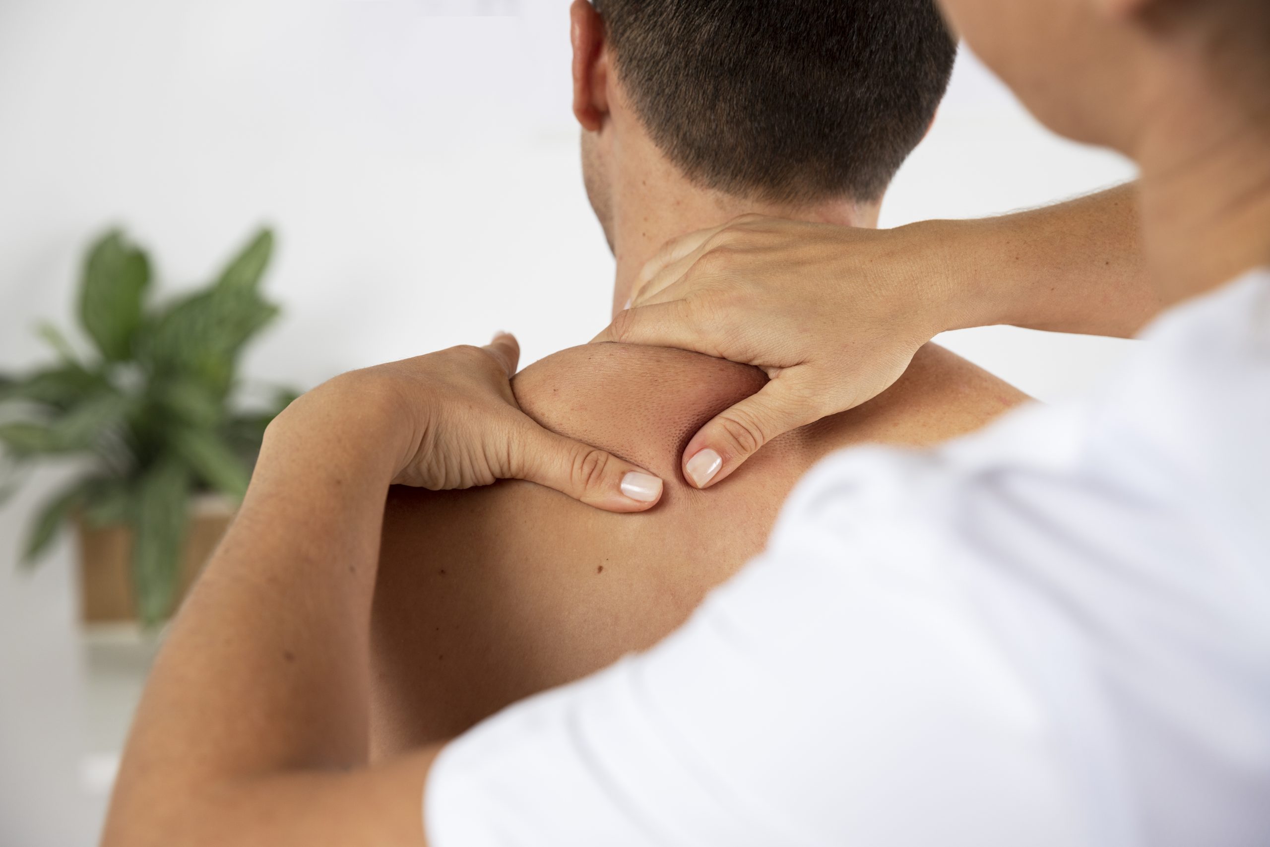 physiotherapist-performing-therapeutic-massage-male-client physiotherapist-performing-therapeutic-massage-male-client